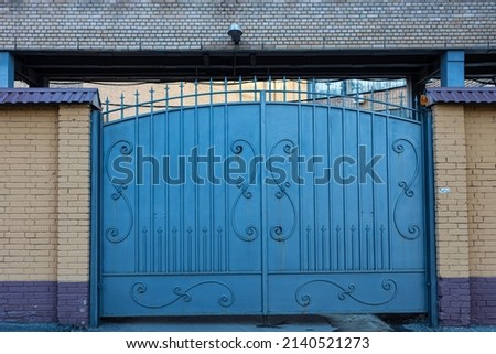 closed large metal gates of blue color. High quality photo
