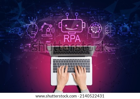 Robotic Process Automation RPA theme with person using a laptop computer Royalty-Free Stock Photo #2140522431