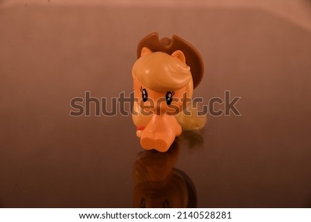 Photo of the polymer element. Using object, horse toy with cowboy hat. Small and cute object, child's toy.