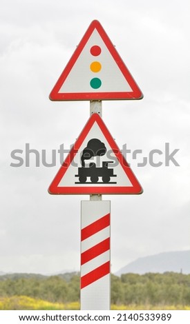 Danger signs, level crossing without barrier and traffic light