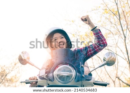 Women tourists driving a motorcycle to explore the nature.