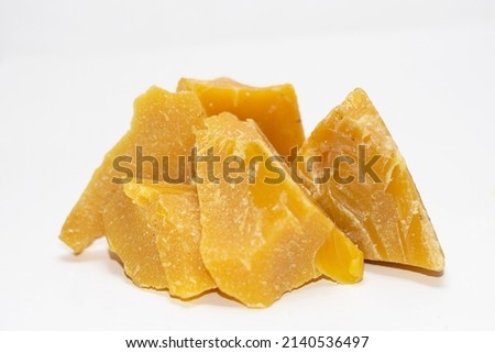 blocks of virgin beeswax stacked on a white background Royalty-Free Stock Photo #2140536497