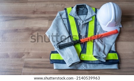 Red stick and security guard uniform.