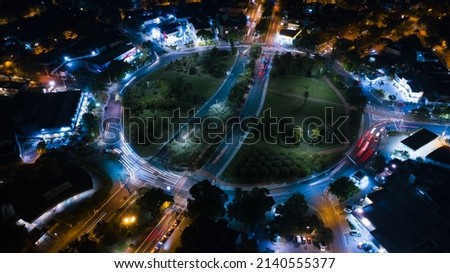 Aerial image of cars circling in long exposure to Pan-American square at night 