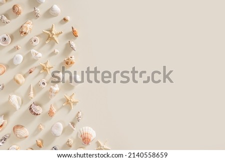 Seashells and starfish with long shadows on beige background. Summer concept. Nautical pattern pastel colored. Aesthetic trend layout shells, sea stars, minimal style creative composition, copy space Royalty-Free Stock Photo #2140558659