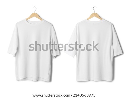 White oversize T shirt mockup hanging isolated on white background with clipping path. Royalty-Free Stock Photo #2140563975