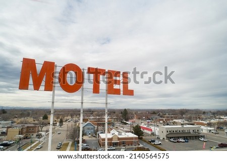 Motel sign with the sky in the background.