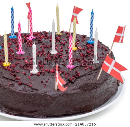 Delicious Chocolate Birthday cake with candles and danish flags isolated on white