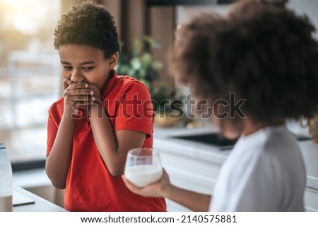 A boy in red shirt refusing from milk Royalty-Free Stock Photo #2140575881