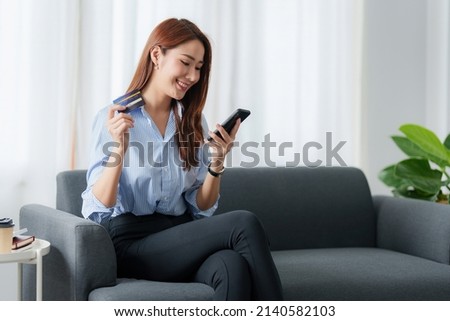 Woman using shopping application by cell phone and payment by credit card