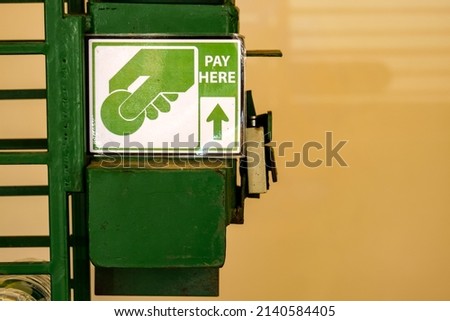 Selective focus of green metal box coins slot of vending machine