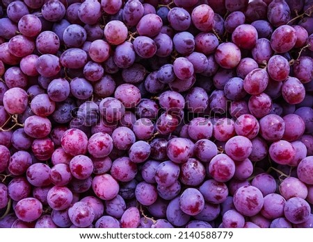 Close up of raw organic sweet red grapes background, wine grapes texture, Healthy fruits Red wine grapes background, top view                                Royalty-Free Stock Photo #2140588779