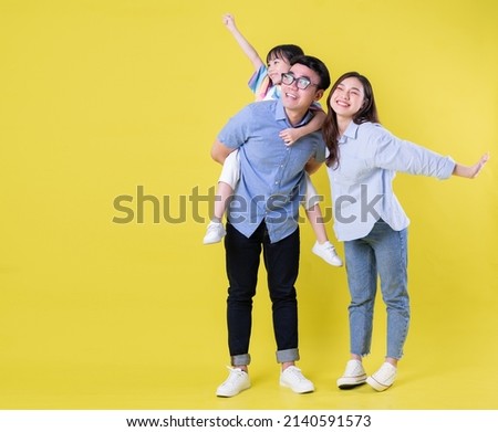 Full length image of young Asian family on background Royalty-Free Stock Photo #2140591573