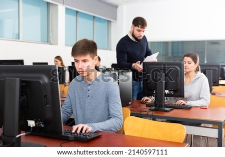Young male student works at computer. High quality photo