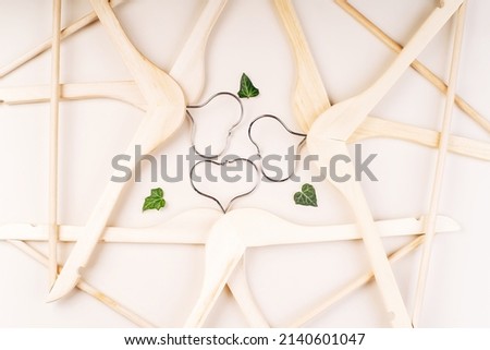 Hangers with plants on white background with copy space.Conscious and environmentally friendly consupmtion in shopping.Recycling or zero waste concept.Shopping,sale,promo concept.