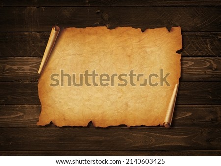 Old mediaeval paper sheet. Horizontal parchment scroll on a wood board background