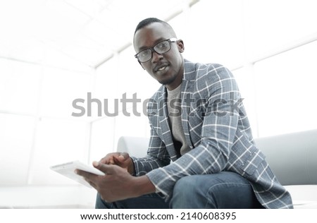 businessman with digital tablet on the background of a bright office