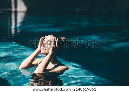 Woman relaxing in the swimming pool. Royalty-Free Stock Photo #2140619061