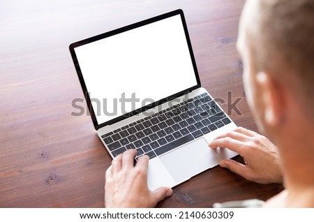Man using laptop computer, blank white screen mockup Royalty-Free Stock Photo #2140630309