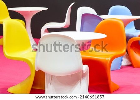 Contemporary multi colored plastic chairs and tables. Kindergarten interior Royalty-Free Stock Photo #2140651857
