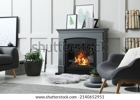 Stylish living room interior with electric fireplace and comfortable furniture