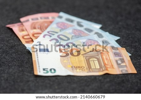 different kinds of banknotes laying on a table