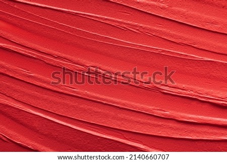 Red shimmering lipstick background texture smudged