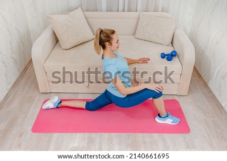 Sportive beautiful girl doing aerobics workout at home