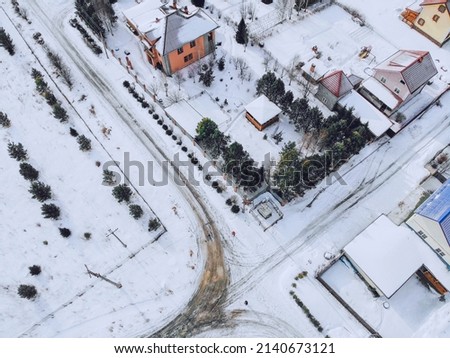March in the village of Mansky, the snow began to melt, wooden cottages, photo from quadcopter