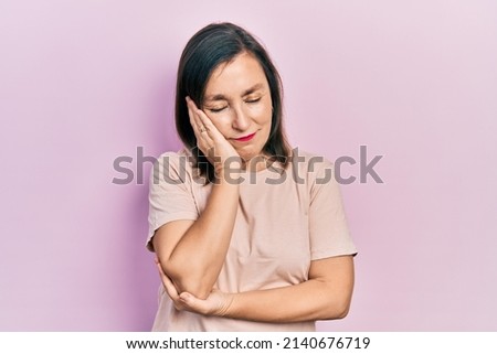 Middle age hispanic woman wearing casual clothes thinking looking tired and bored with depression problems with crossed arms. 