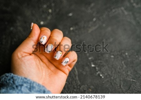 Women's hands with colorful pattern on the nails. 2022 colors trend. Top view. Place for text. support Ukraine