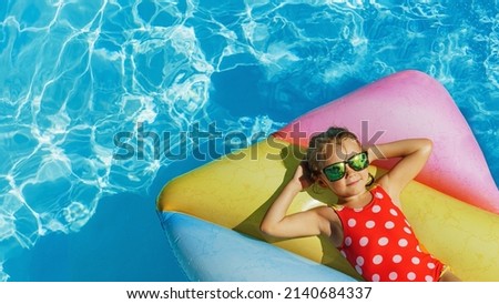 Child in swimming pool. Having fun on vacation at the hotel pool. Colorful vacation concept. Royalty-Free Stock Photo #2140684337