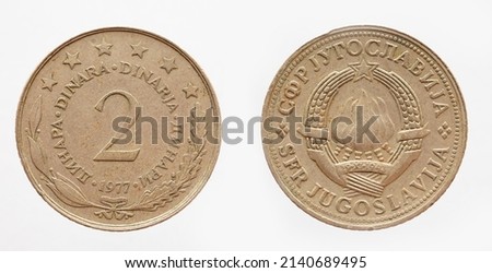 yugoslavia - circa 1977: a 2 Dinar coin of yugoslavia showing a torch fire as a coat of arms  Royalty-Free Stock Photo #2140689495
