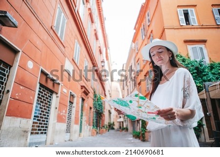Travel tourist woman with map in Rome outdoors during holidays in Europe.