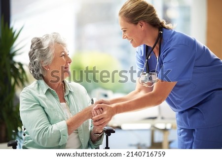 She has a great way with her patiends. Shot of a doctor shaking hands with a smiling senior woman sitting in a wheelchair. Royalty-Free Stock Photo #2140716759