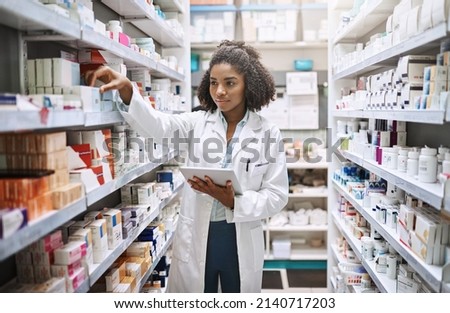Never fear, your pharmacist is here. Cropped shot of an attractive young female pharmacist working in a pharmacy. Royalty-Free Stock Photo #2140717203