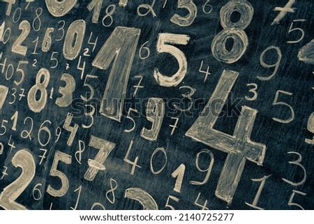 picture with random numbers drawn with chalk on the board at university or school. 
Math lesson with formulas and numbers