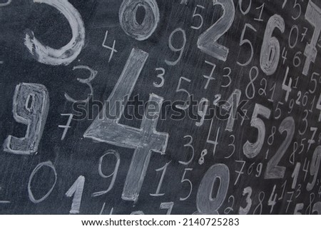 picture with random numbers drawn with chalk on the board at university or school. 
Math lesson with formulas and numbers