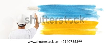 peace and stop the war in ukraine, concept, painter man paint yellow and blue colors of the flag of Ukraine. isolated on white wall
