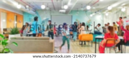 Blurred background for your text message or advertising promotional content, young happy team members silhouette celebrating successful finishing of startup project in bright office high fiving