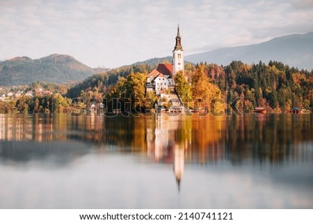 Colorful autumn view of Bled lake in Julian Alps, Slovenia. Pilgrimage church of the Assumption of Maria on a foreground. Landscape photography