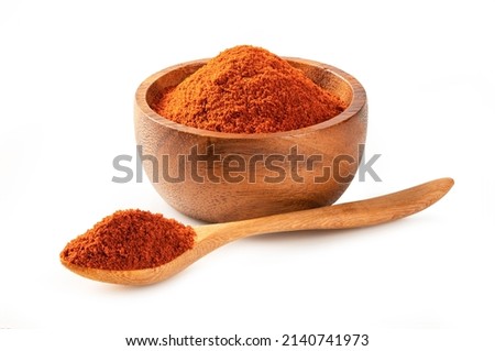 Paprika powder ( bell pepper) in wooden bowl and spoon isolated on white background. Royalty-Free Stock Photo #2140741973