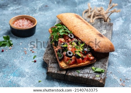 Italian ciabatta with chopped tomato vegetables, herbs and oil on grilled or toasted crusty baguette. Delicious breakfast or snack, Clean eating, dieting, vegan food concept. top view,