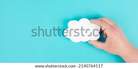 Holding a white cloud in the hand, empty copy space for text, blue  background, communication and marketing concept, being connected, networking