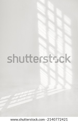 Window shadow overlay on a white wall background. Royalty-Free Stock Photo #2140772421