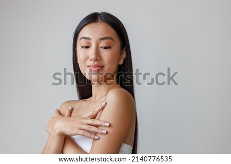 Asian young woman with natural makeup standing in studio