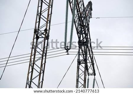 Steel pillar with high voltage electric power lines delivering electrical energy through cable wires on long distance