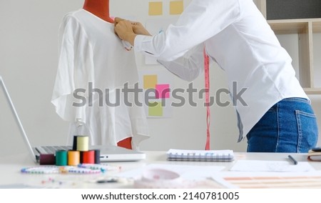 Tailor woman working in tailor shop Stylish Fashion designer tailor in workshop studio designing new collection Dressmaking and Creative fashion collection   Royalty-Free Stock Photo #2140781005