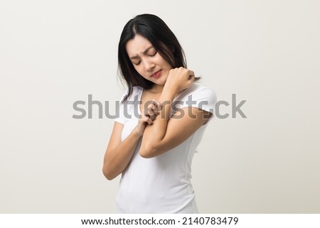 Asian women have skin problems She felt irritation on her skin. Skin infection itching red rash scratching with hands. She around 25 Wearing white shirt standing on isolate background Royalty-Free Stock Photo #2140783479