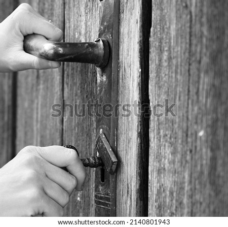 hand locking a big gate to a property stock photo 